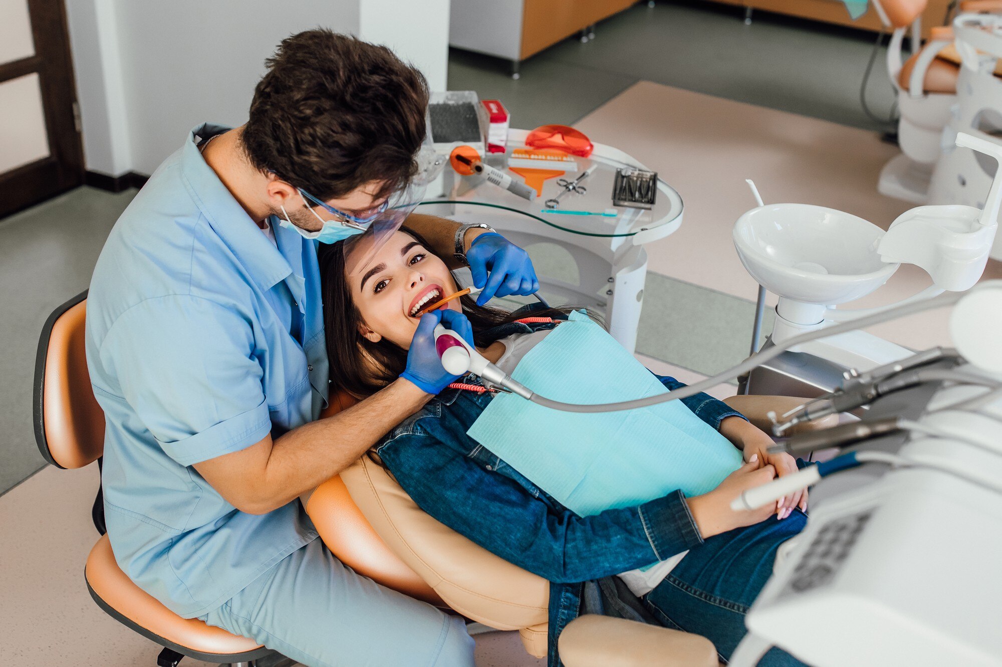 young-female-patient-with-open-mouth-examining-dental-inspection-dentist-office_496169-976